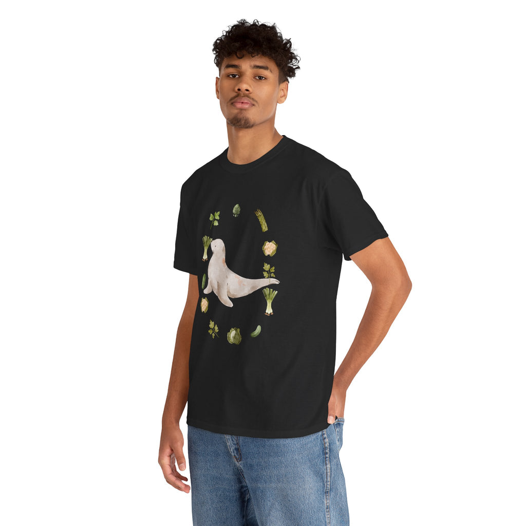 A man wearing black t-shirt featuring a graphic design of a sea lion surrounded by green onions, cabbage, and broccoli.