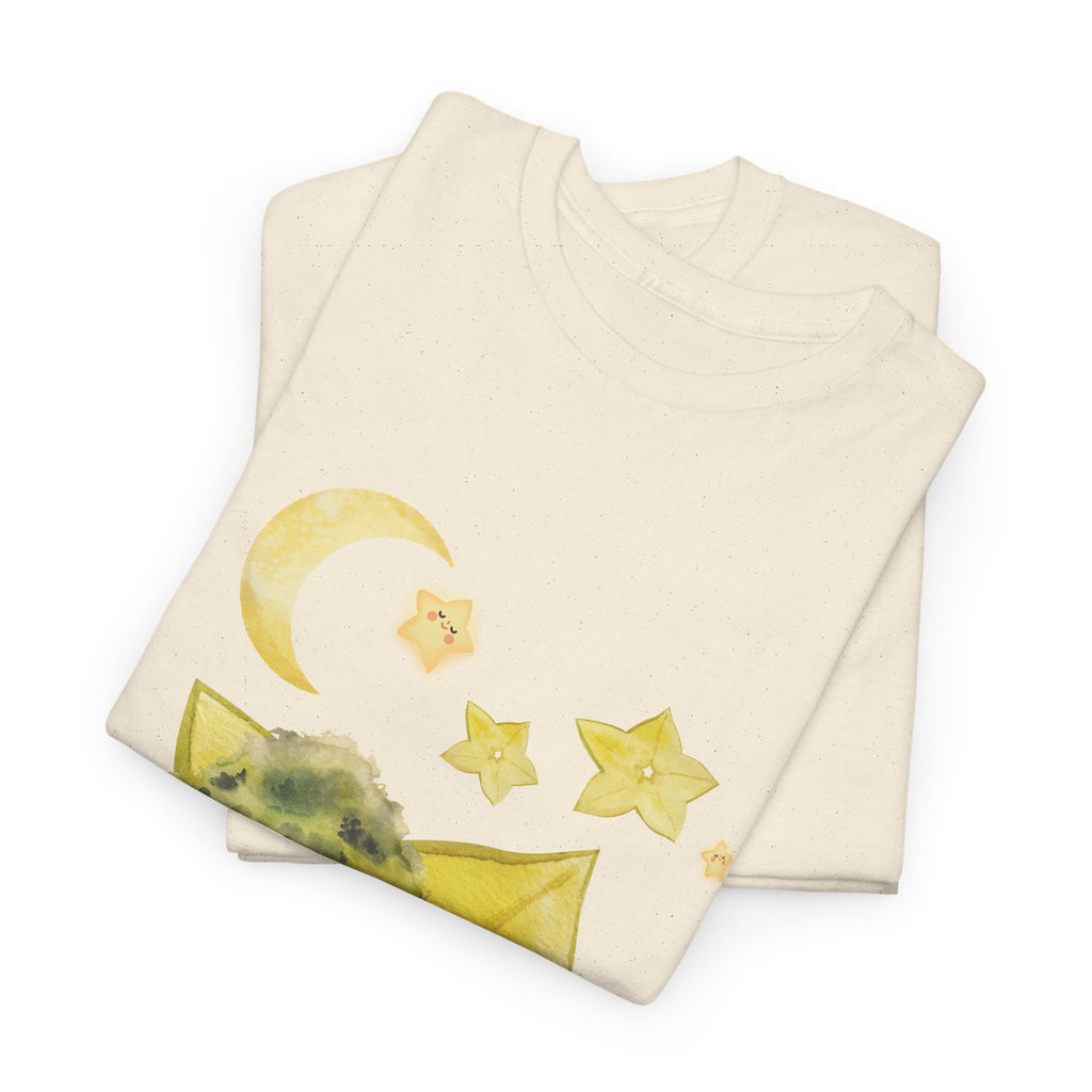 A folded beige t-shirt featuring a graphic design of a tree stump, leaves, and starfruit celestial elements.