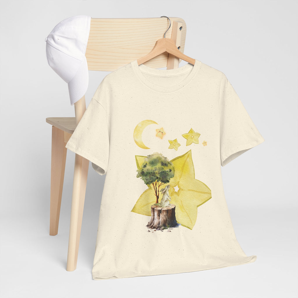 A beige t-shirt hanging on a chair, featuring a graphic design of a tree stump, leaves, and starfruit celestial elements.