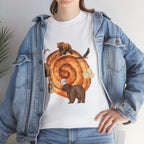 A girl wearing a denim jacket over a white t-shirt featuring a colorful design of a cinnamon roll surrounded by several hungry bears.