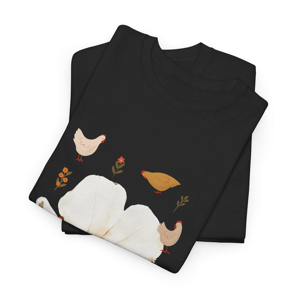 A folded black t-shirt featuring a graphic design of a bloom surrounded by roosters in various poses.