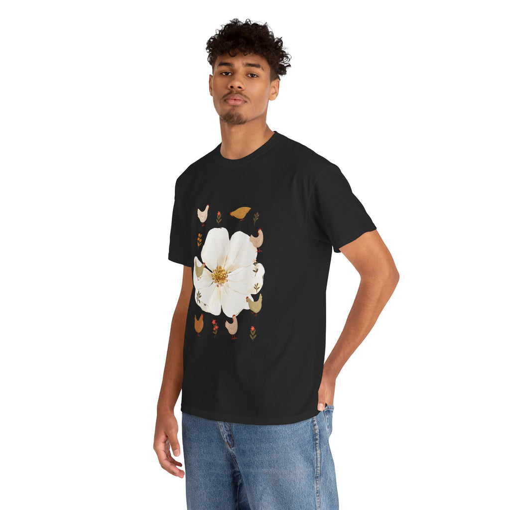 A man wearing a black t-shirt featuring a graphic design of a bloom surrounded by roosters in various poses.
