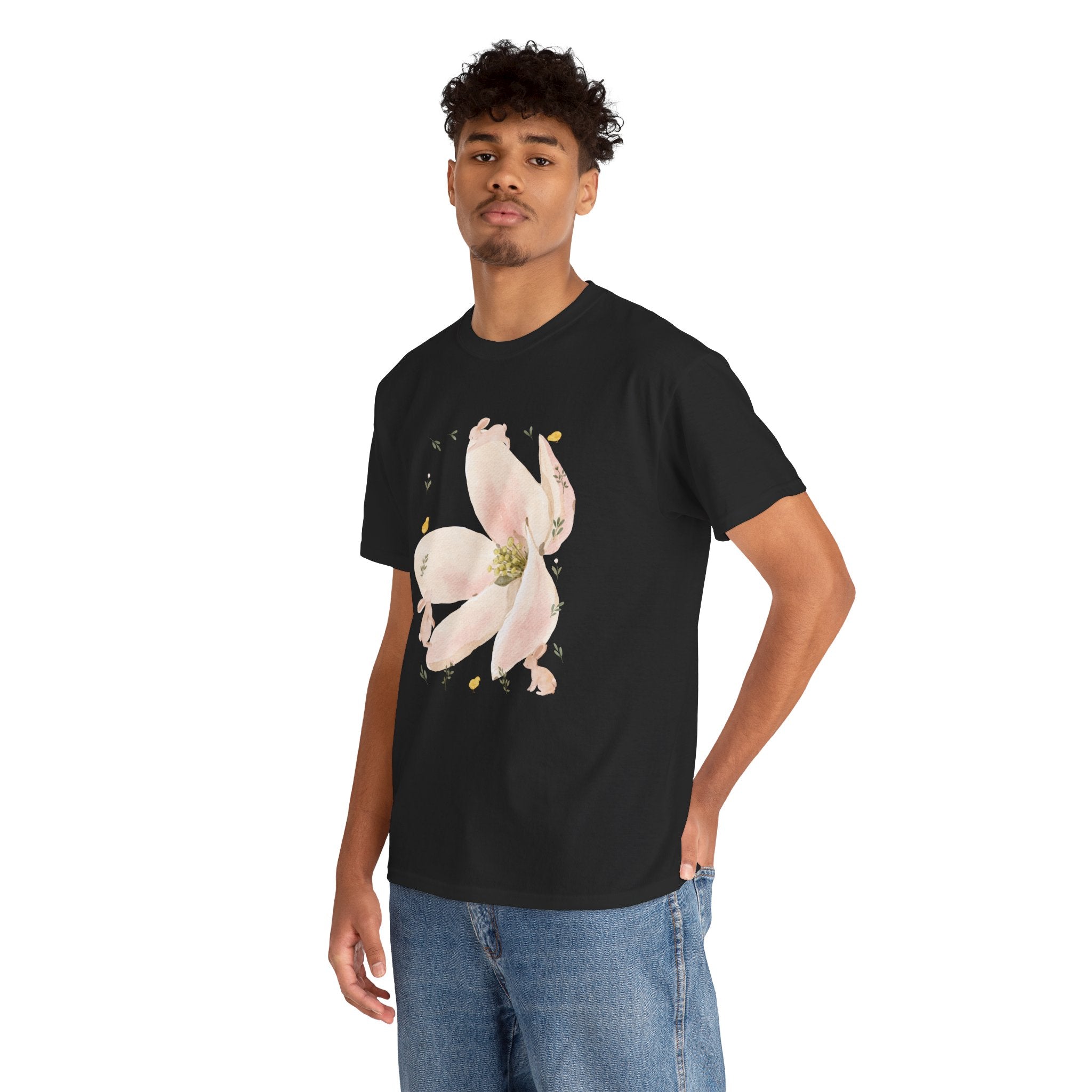 A man wearing a black t-shirt featuring a graphic design of a pink bloom surrounded by bunnies in various poses.