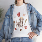 A girl wearing a denim jacket over a white t-shirt featuring a colorful design of a dog in a baseball hat surrounded by a circle of balls, bats, and helmets.