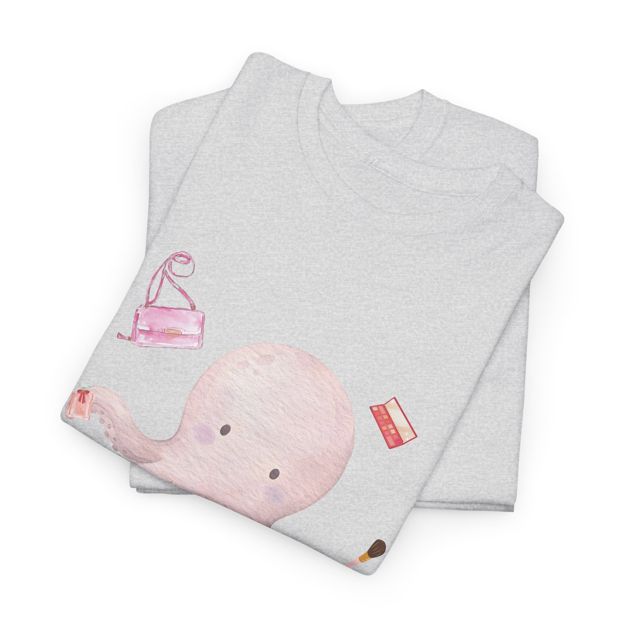 A folded grey t-shirt featuring a graphic design of a pink octopus multitasking its tentacles to apply lipstick, brush on makeup, and juggle beauty accessories.