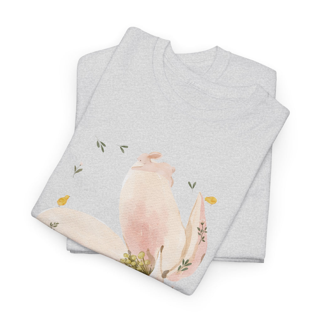A folded grey t-shirt featuring a graphic design of a pink bloom surrounded by bunnies in various poses.