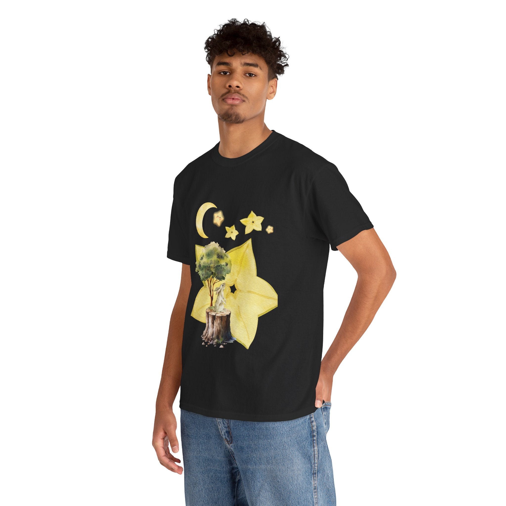 A man wearing a black t-shirt featuring a graphic design of a tree stump, leaves, and starfruit celestial elements.