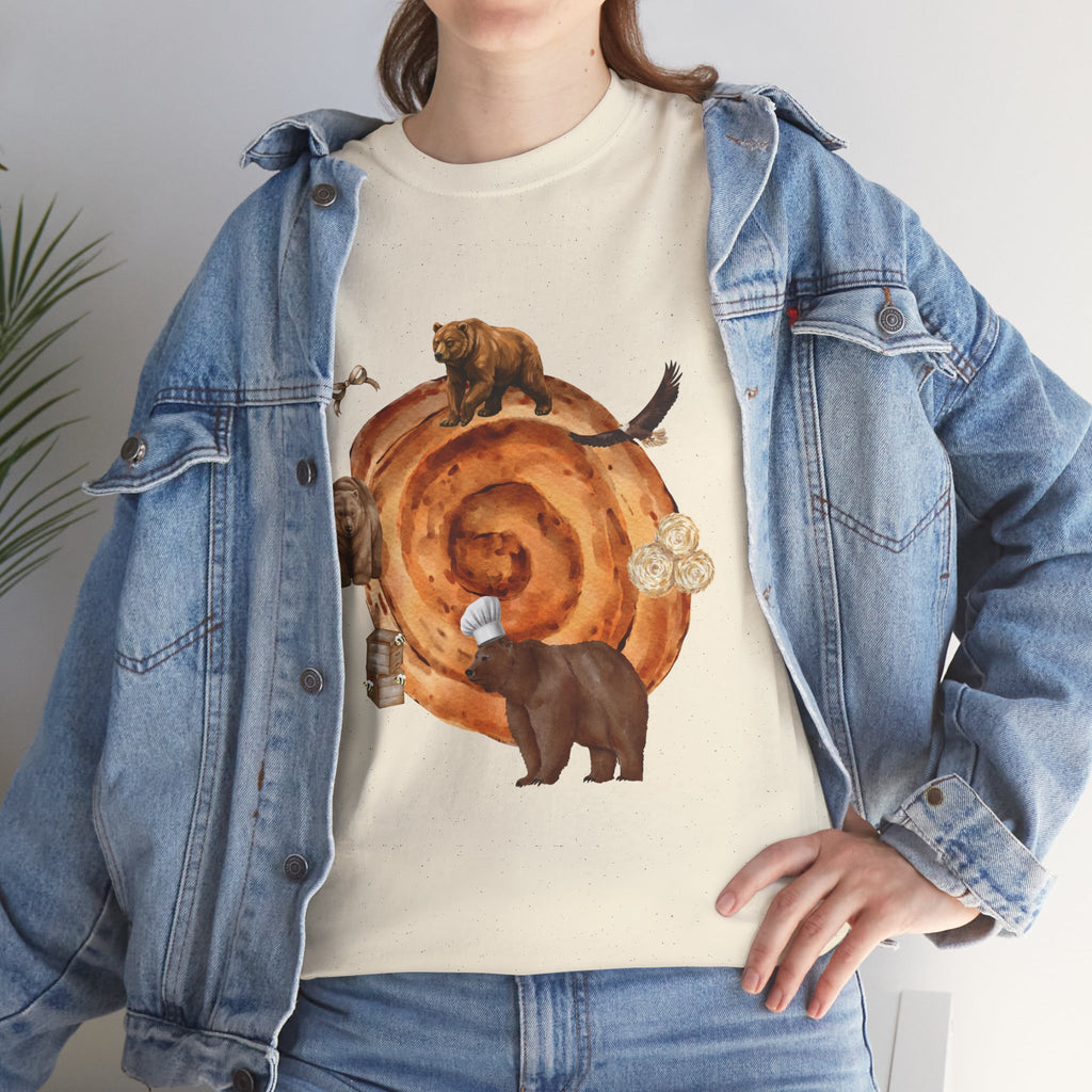 A girl wearing a denim jacket over a beige t-shirt featuring a colorful design of a cinnamon roll surrounded by several hungry bears.