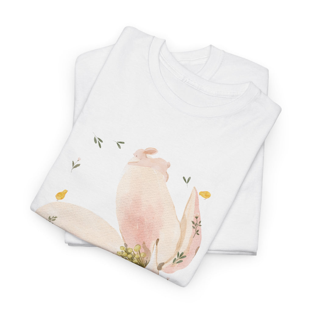 A folded white t-shirt featuring a graphic design of a pink bloom surrounded by bunnies in various poses.
