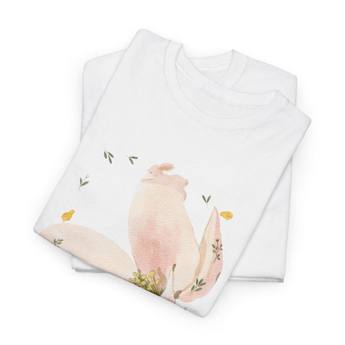 A folded white t-shirt featuring a graphic design of a pink bloom surrounded by bunnies in various poses.