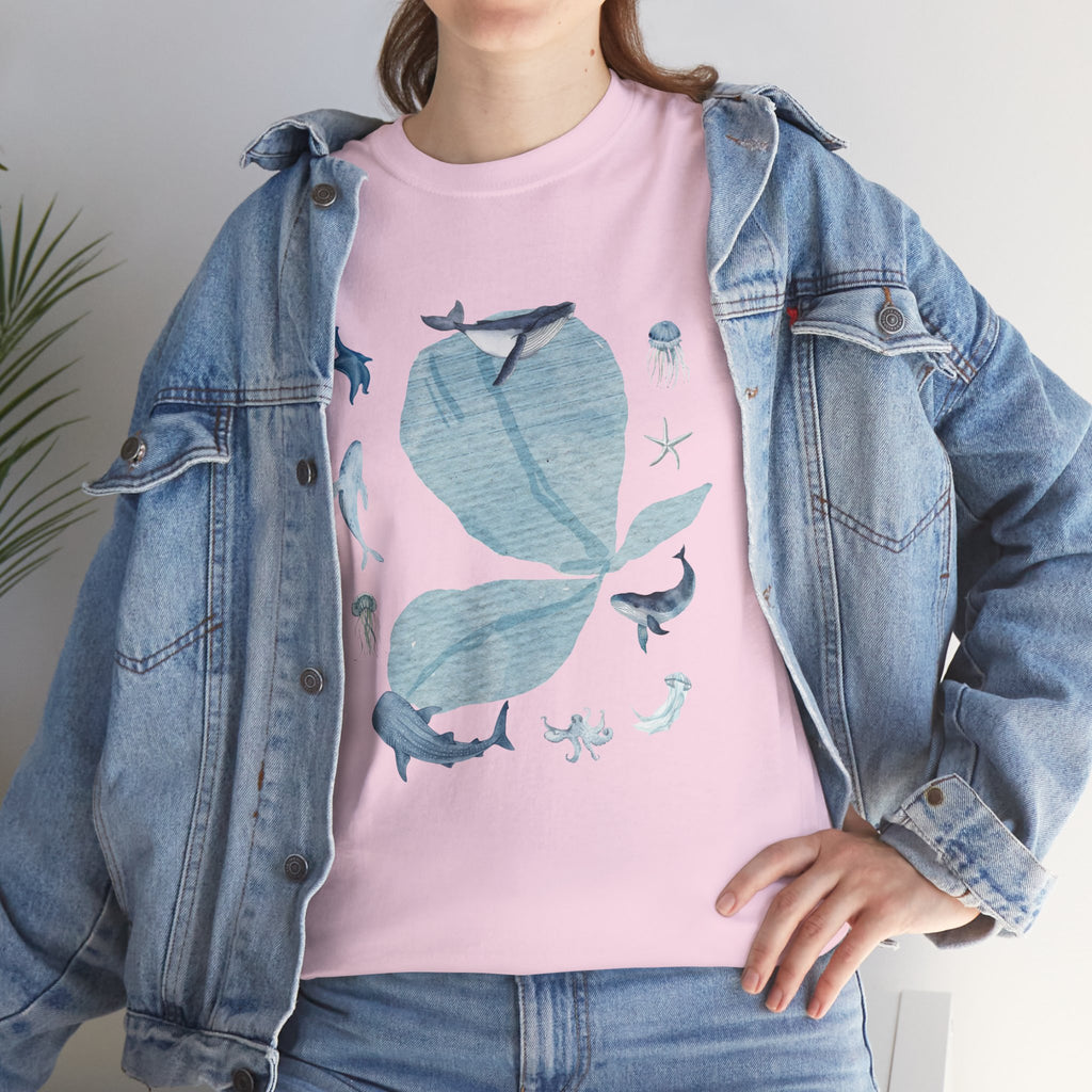 A girl wearing a denim jacket over a pink t-shirt featuring a colorful design of a pink bloom surrounded by bunnies in various poses.