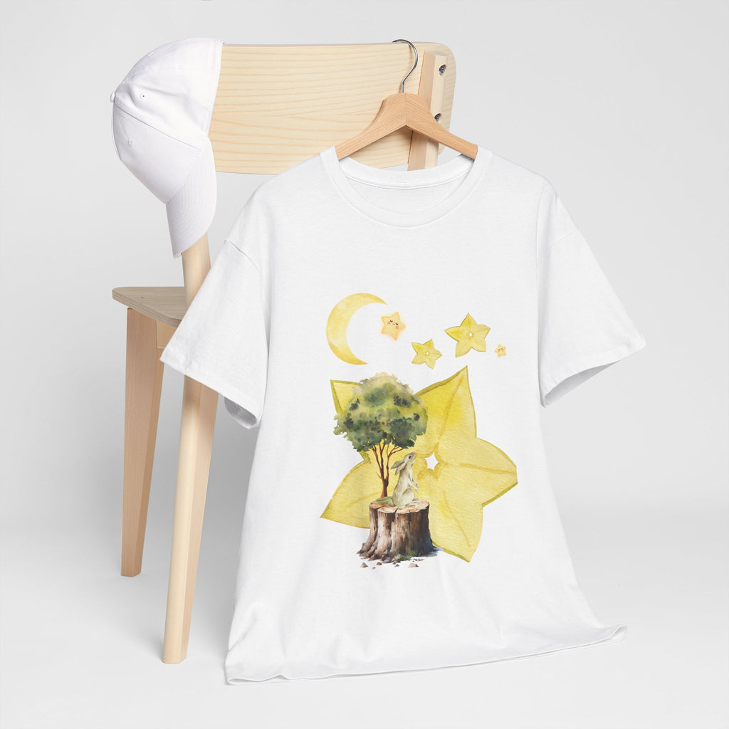 A white t-shirt hanging on a chair, featuring a graphic design of a tree stump, leaves, and starfruit celestial elements.