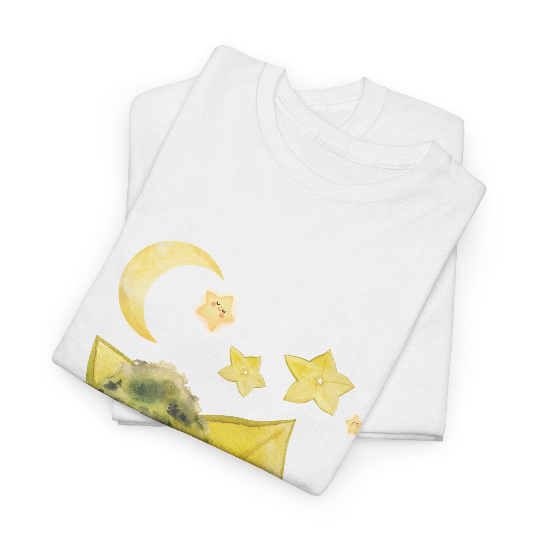 A folded white t-shirt featuring a graphic design of a tree stump, leaves, and starfruit celestial elements.