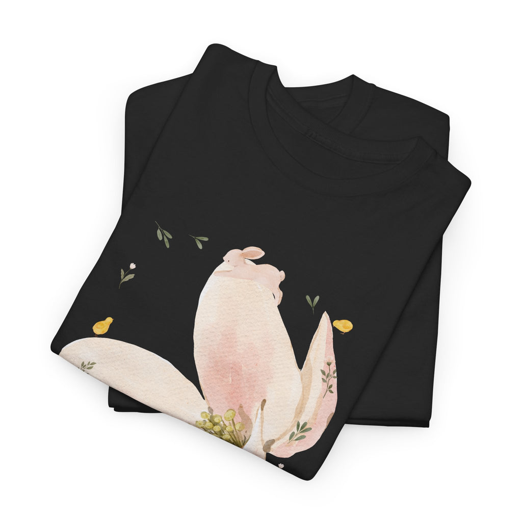 A folded black t-shirt featuring a graphic design of a pink bloom surrounded by bunnies in various poses.