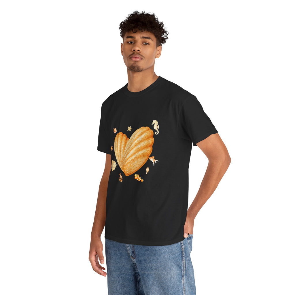 A man wearing a black t-shirt featuring a graphic design of a heart-shaped madeleine surrounded by yellow tropical fish, starfish, seahorses, and coral.