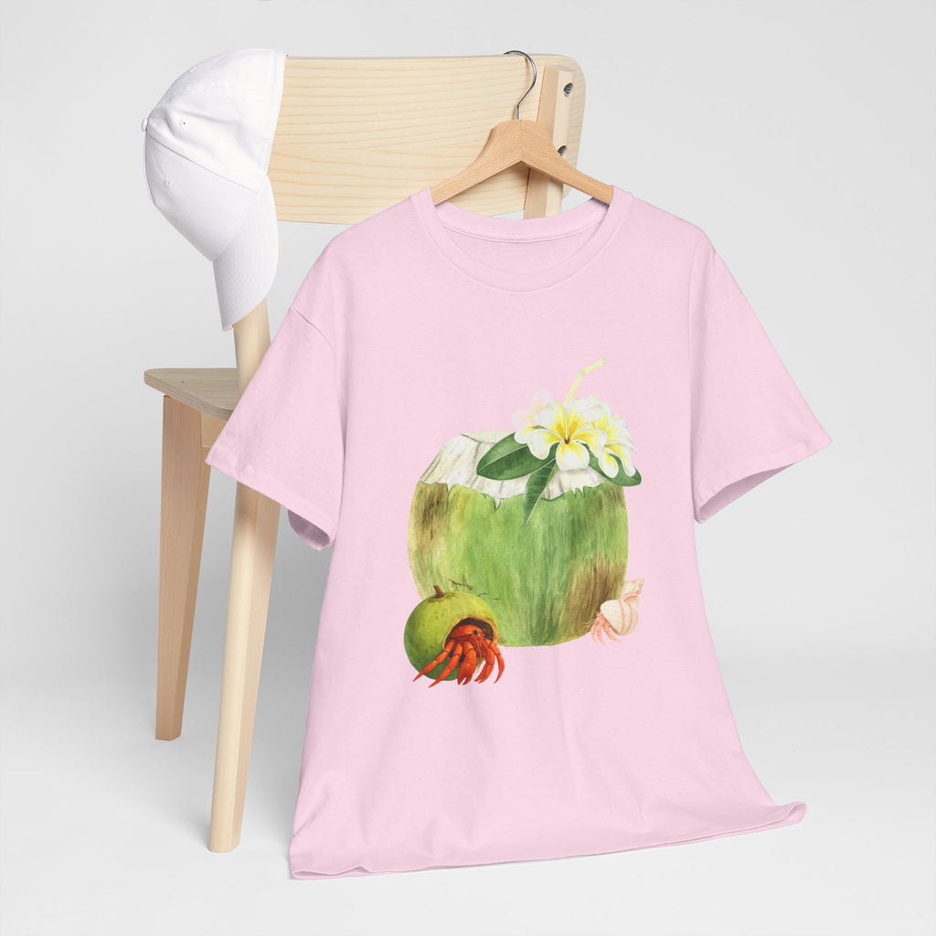 A pink t-shirt hanging on a chair, featuring a graphic design of a hermit crab in a coconut shell and a straw-topped coconut.