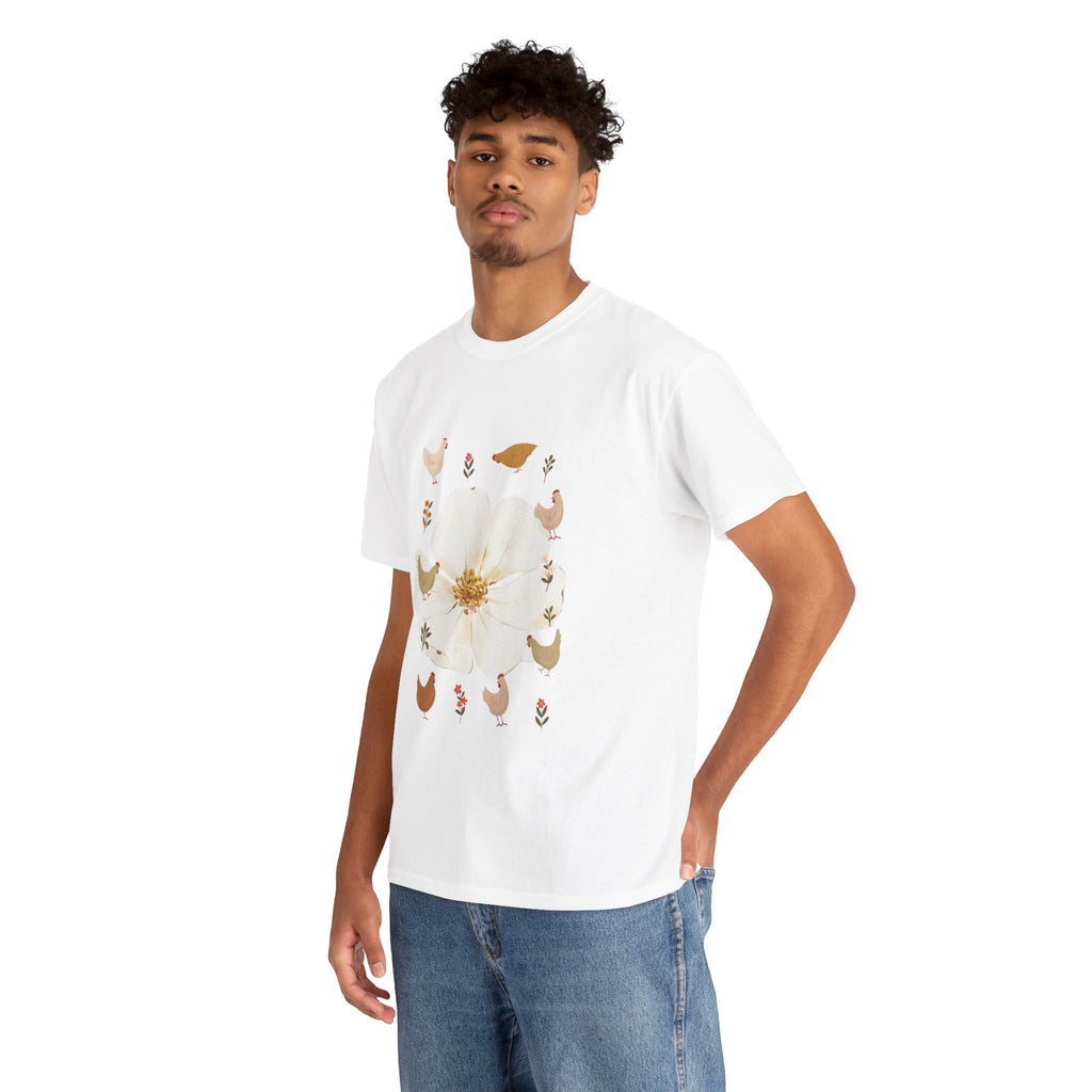 A man wearing a white t-shirt featuring a graphic design of a bloom surrounded by roosters in various poses.