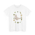 White t-shirt with a sea lion surrounded by green onions, cabbage, and broccoli.