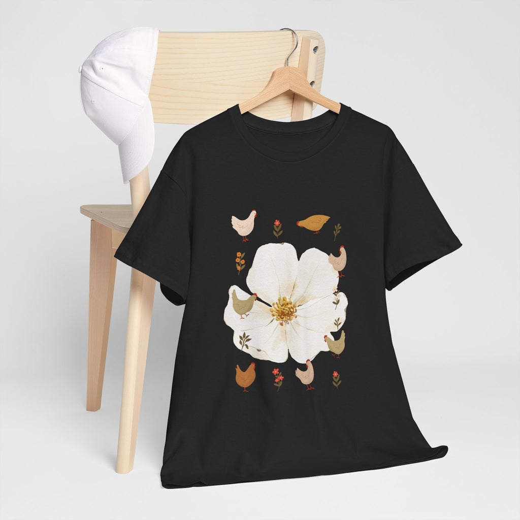 A black t-shirt hanging on a chair, featuring a graphic design of a bloom surrounded by roosters in various poses.