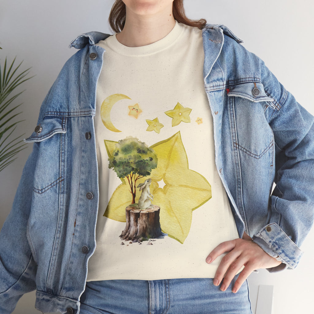 A girl wearing a denim jacket over a beige t-shirt featuring a colorful design of a tree, moon, and starfruit celestial elements.
