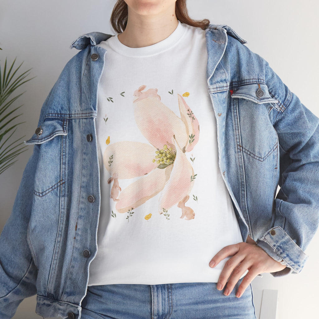 A girl wearing a denim jacket over a white t-shirt featuring a colorful design of a pink bloom surrounded by bunnies in various poses.