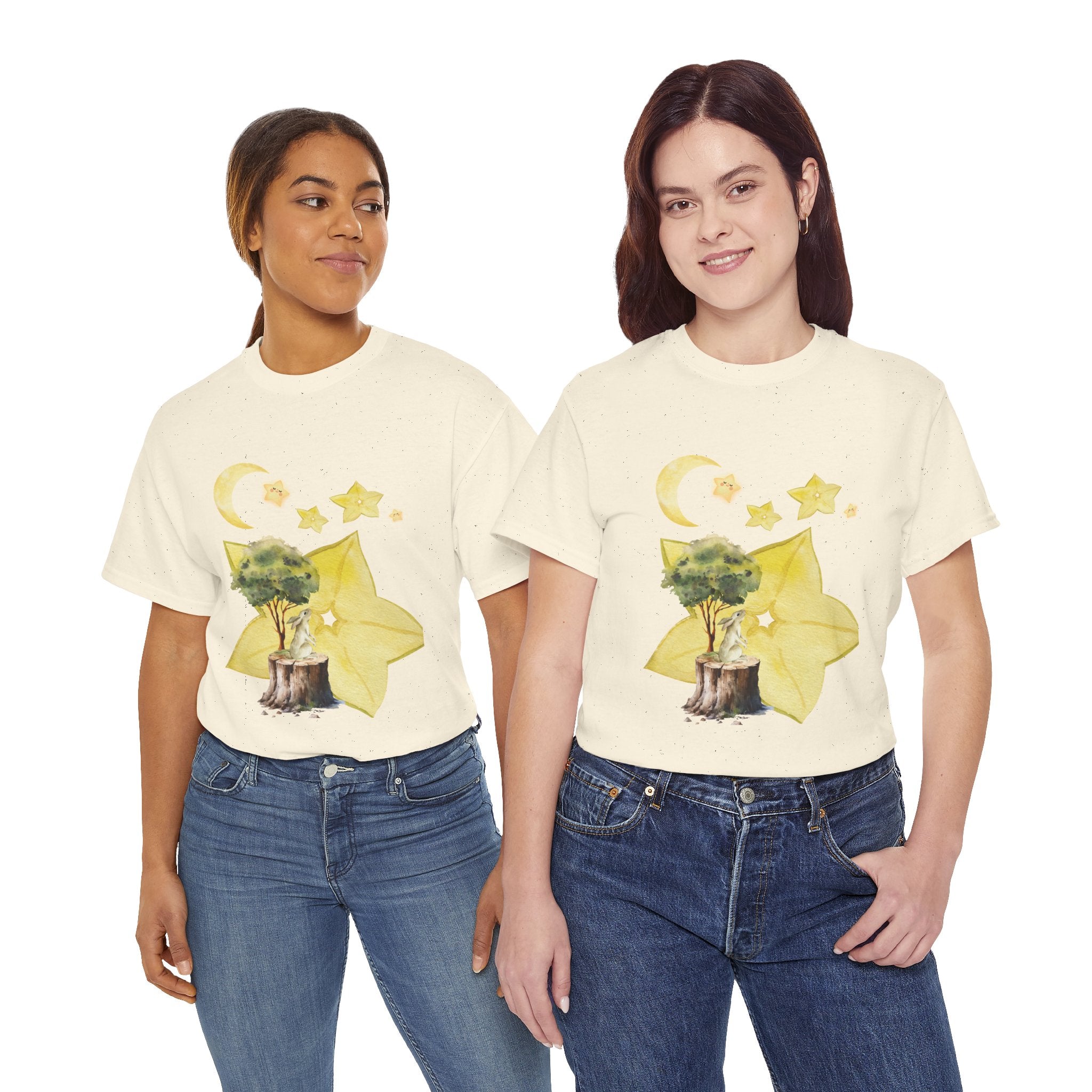 Two girls wearing beige t-shirts featuring a graphic design of a tree stump, leaves, and starfruit celestial elements.