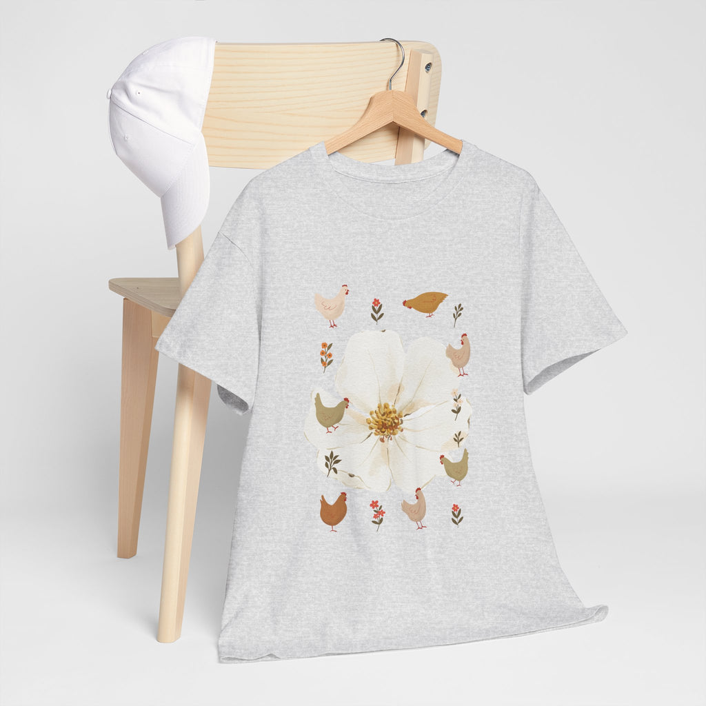 A grey t-shirt hanging on a chair, featuring a graphic design of a bloom surrounded by roosters in various poses.