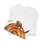 A folded white t-shirt featuring a graphic design of a cinnamon roll surrounded by several hungry bears.