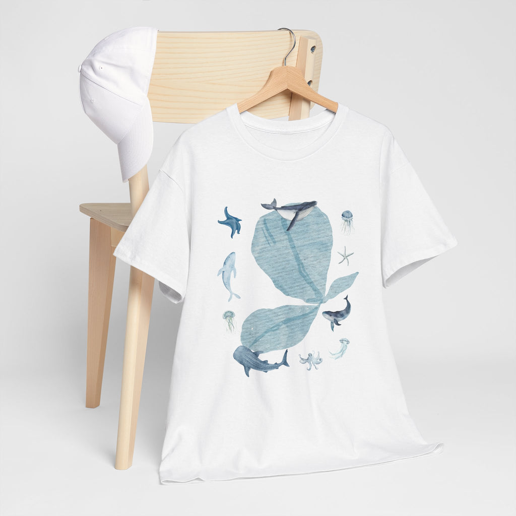 A white t-shirt hanging on a chair, featuring a graphic design of a blue bloom surrounded by whales, jellyfish, and starfish.