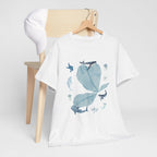 A white t-shirt hanging on a chair, featuring a graphic design of a blue bloom surrounded by whales, jellyfish, and starfish.