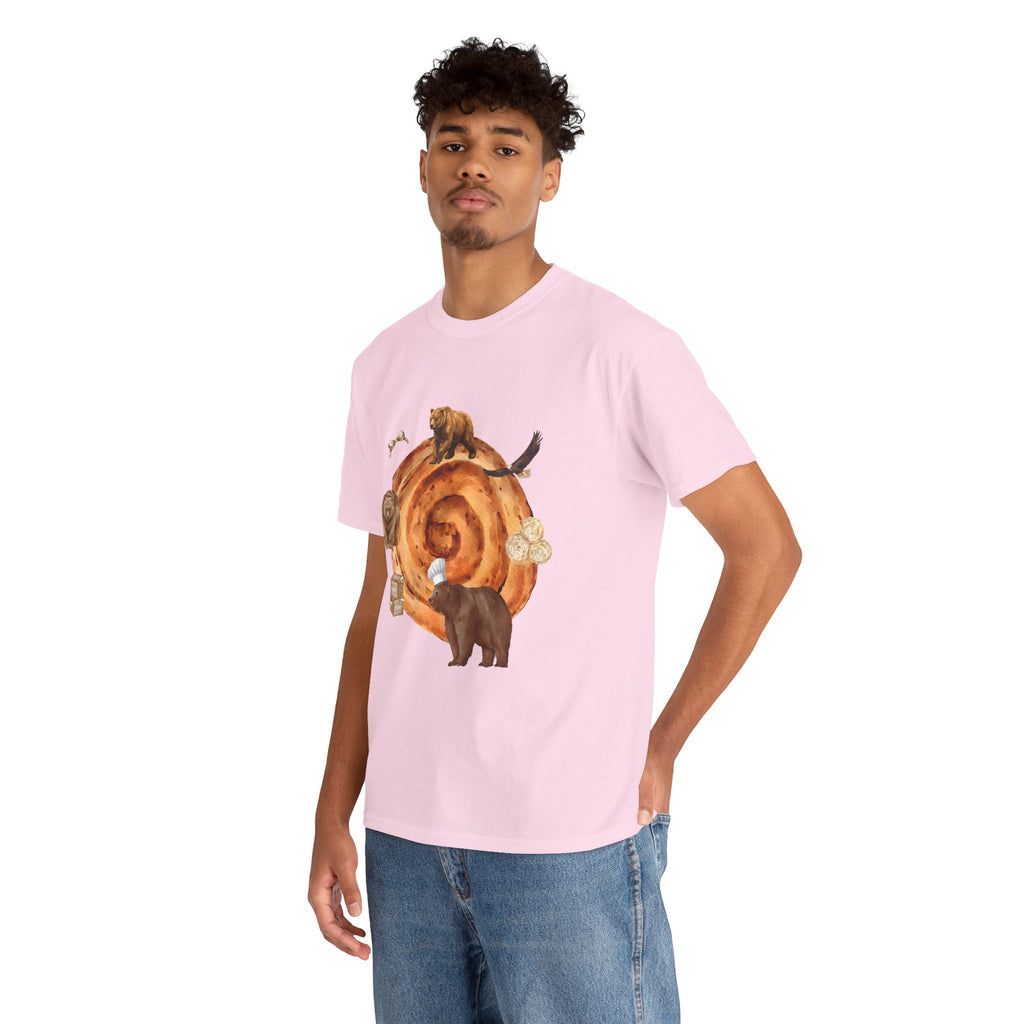 A man wearing a pink t-shirt featuring a graphic design of a cinnamon roll surrounded by several hungry bears.