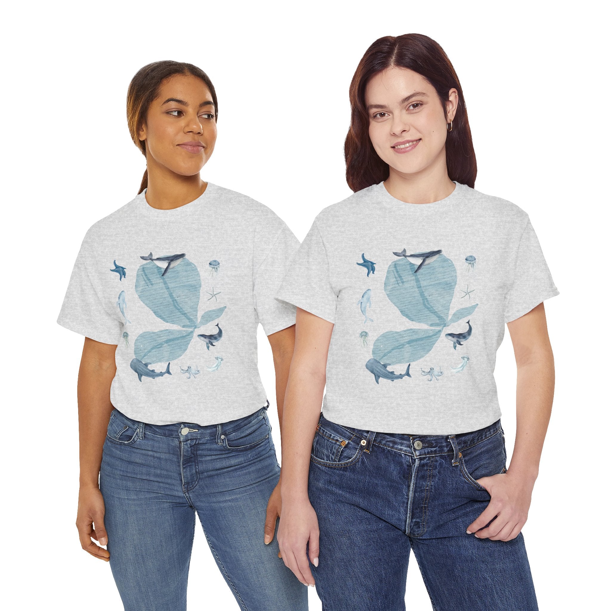 Two girls wearing grey t-shirts featuring a graphic design of a blue bloom surrounded by whales, jellyfish, and starfish.