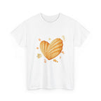 White t-shirt with a heart-shaped madeleine surrounded by yellow tropical fish, starfish, seahorses, and coral.