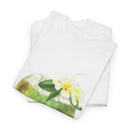 A folded white t-shirt featuring a graphic design of a hermit crab in a coconut shell and a straw-topped coconut.