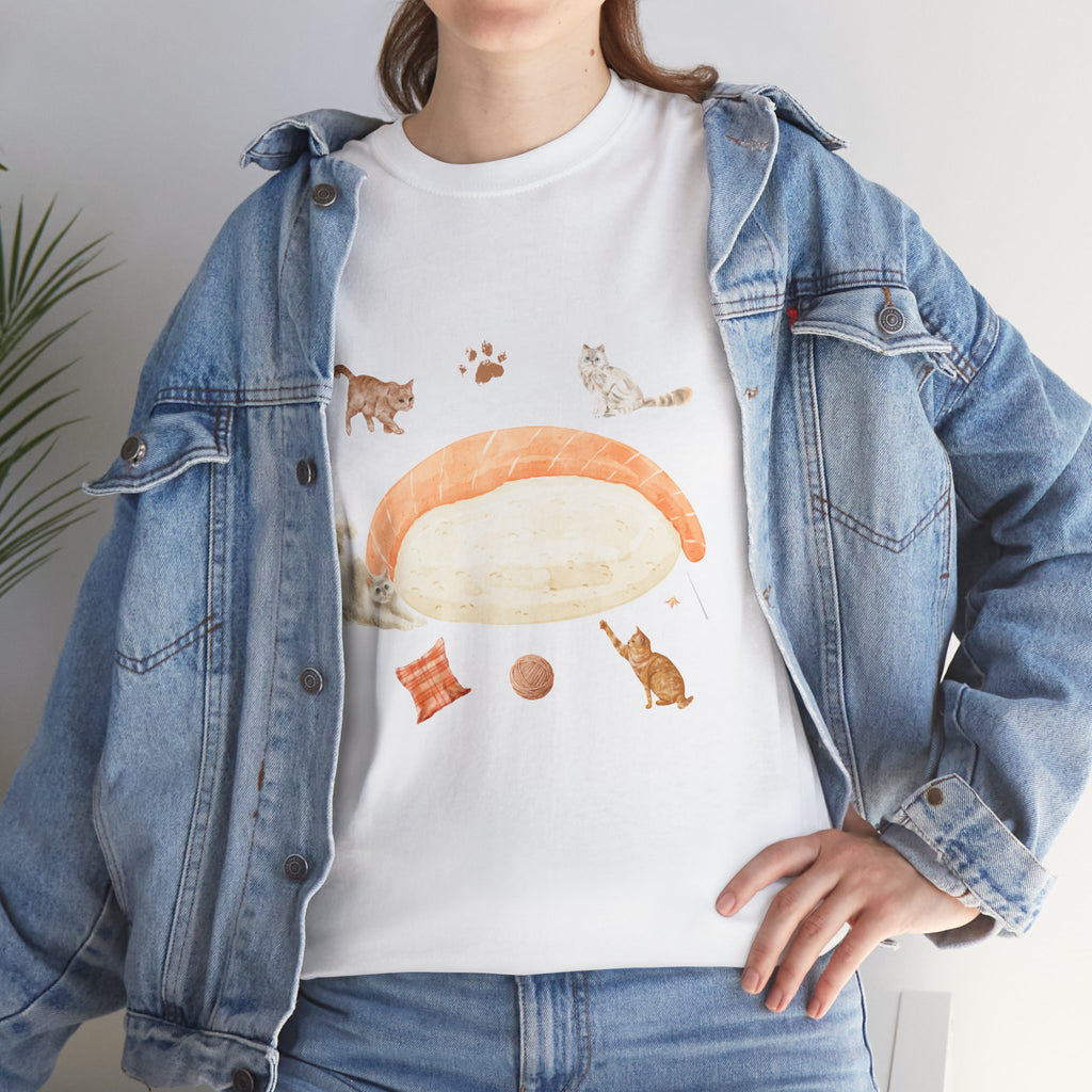 A girl wearing a denim jacket over a white t-shirt featuring a colorful design of a piece of nigiri sushi surrounded by a circle of cats, yarn balls, and cushions.