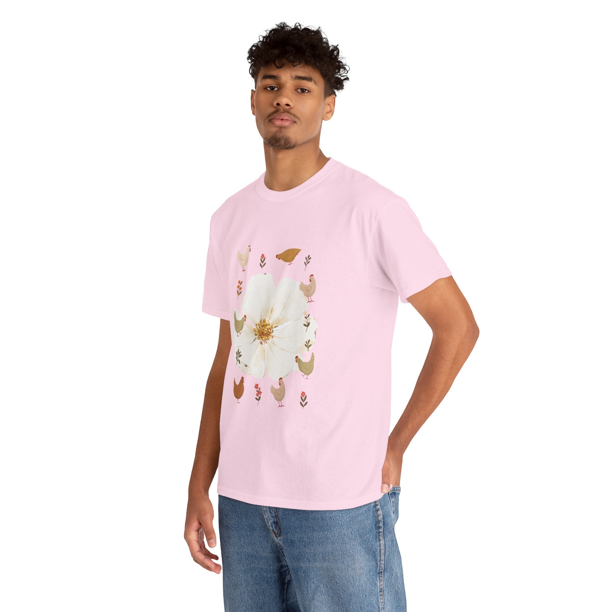 A man wearing a pink t-shirt featuring a graphic design of a bloom surrounded by roosters in various poses.