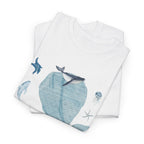 A folded white t-shirt featuring a graphic design of a blue bloom surrounded by whales, jellyfish, and starfish.