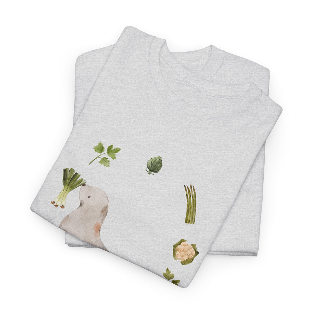 A folded grey t-shirt featuring a graphic design of a sea lion surrounded by green onions, cabbage, and broccoli.