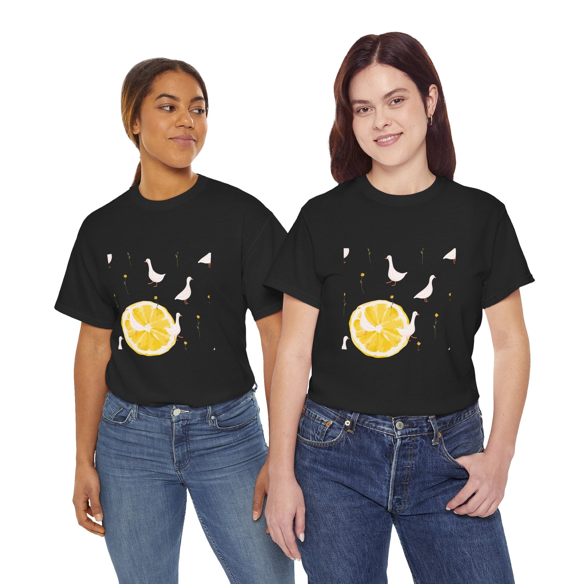 Two girls wearing black t-shirts featuring a graphic design of white ducks filling the frame and a juicy lemon in the bottom-left corner.