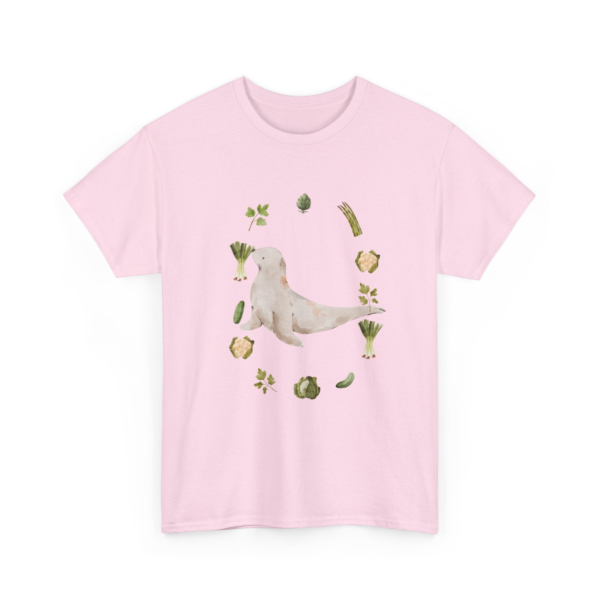 Pink t-shirt with a sea lion surrounded by green onions, cabbage, and broccoli.