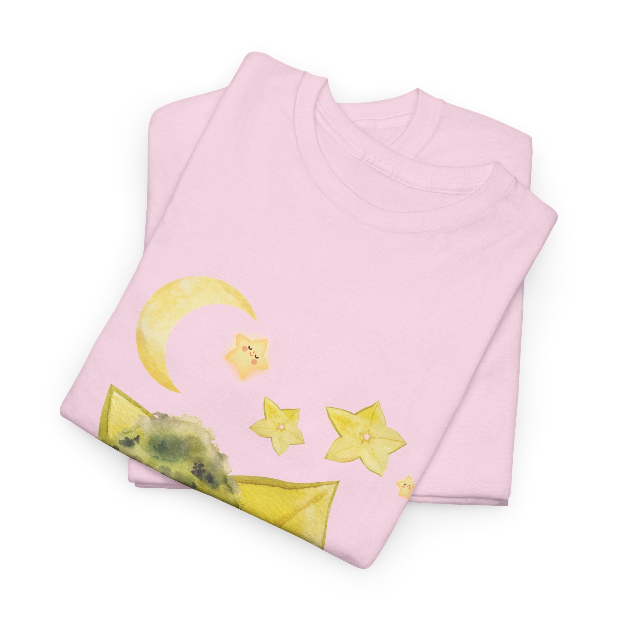 A folded pink t-shirt featuring a graphic design of a tree stump, leaves, and starfruit celestial elements.