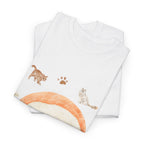 A folded white t-shirt featuring a graphic design of a piece of nigiri sushi surrounded by a circle of cats, yarn balls, and cushions.