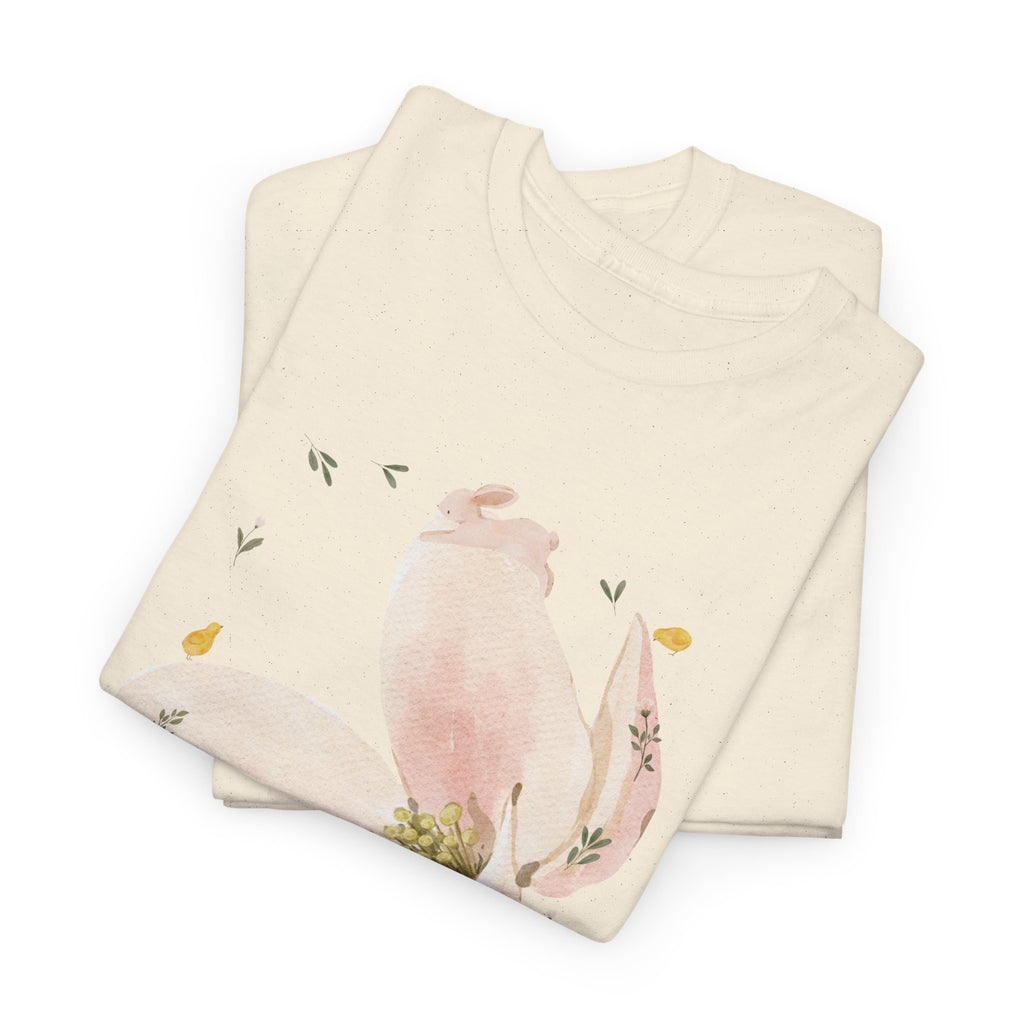A folded beige t-shirt featuring a graphic design of a pink bloom surrounded by bunnies in various poses.
